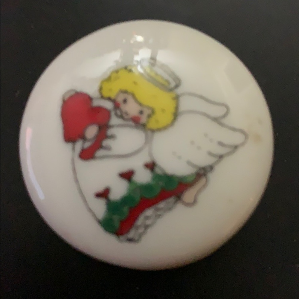 Small vintage trinket box angel holding a heart